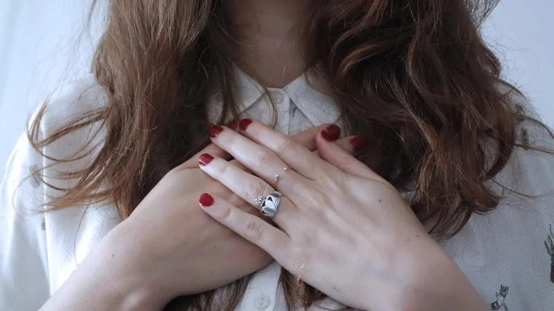Hands showing a finished deep-red manicure